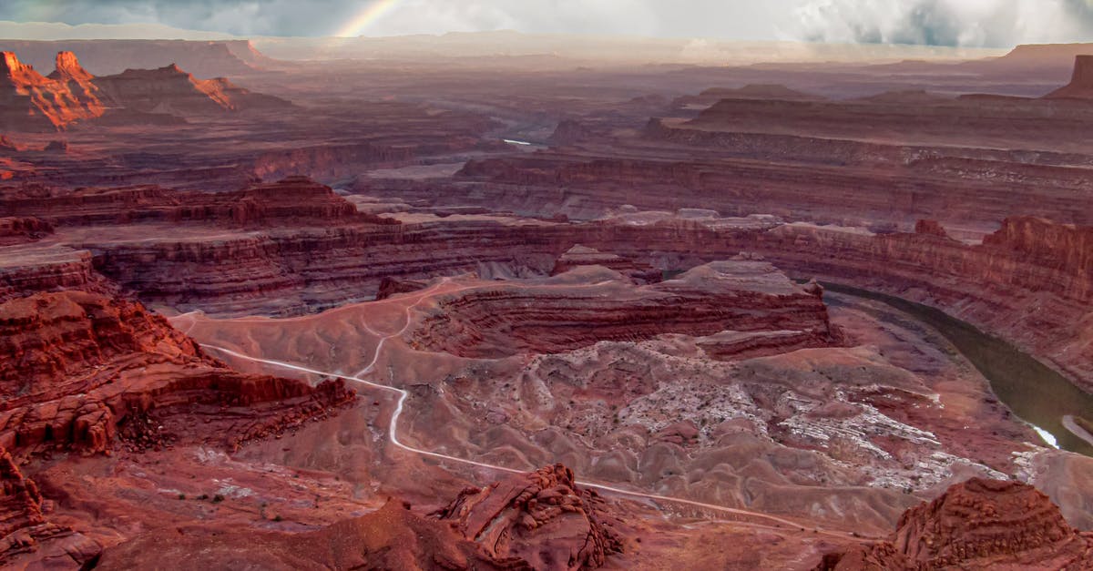 Is free-range veal available in the US? - Amazing view of scenic canyon with red colored rock formations and narrow curvy river under blue sky with picturesque rainbow