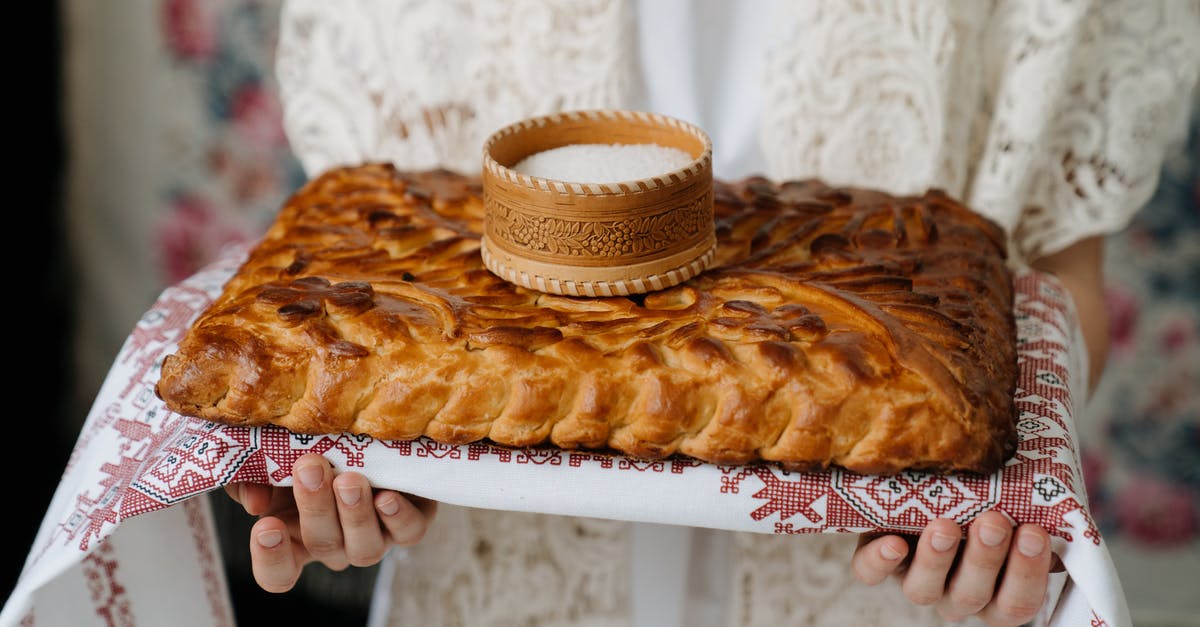 Is iodized salt unsuitable for baking bread? - Person Holding Brown Pastry on White Plate