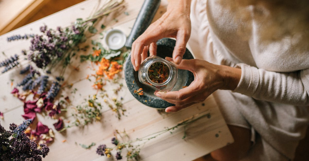 Is it a good idea to grind dried oregano with a mortar and pestle? - A Person Holding a Bottle