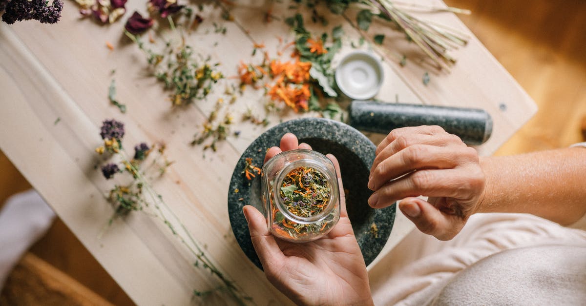 Is it a good idea to grind dried oregano with a mortar and pestle? - Person Holding Gold Ring With Clear Gemstone
