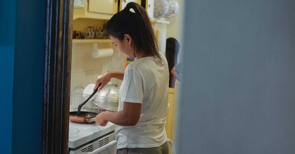 Is it common for slow cookers to heat unevenly? - Woman cooking lunch in light kitchen