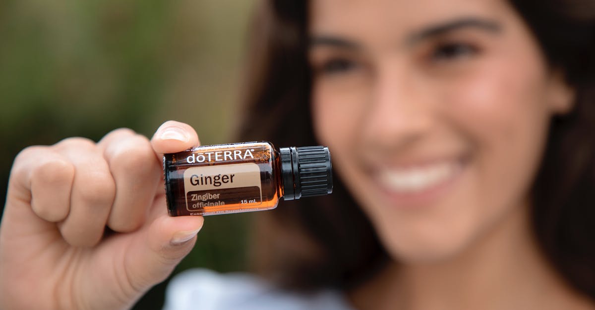 Is it normal for ginger paste to spit violently in oil? - A Woman Holding a Doterra Ginger Essential Oil