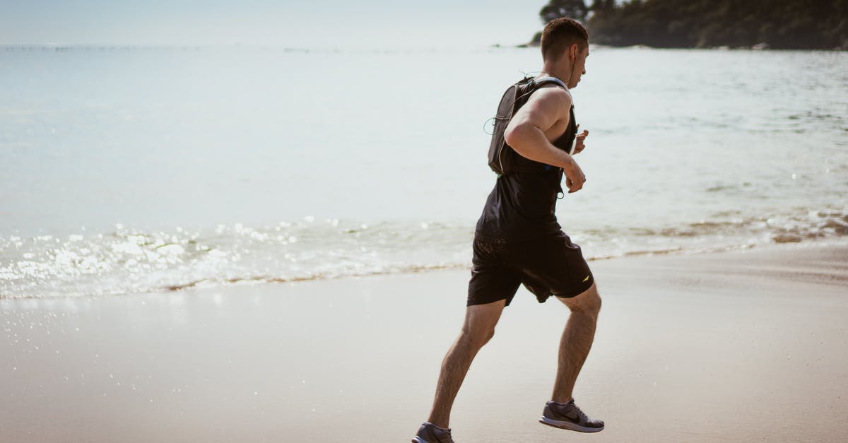 Is it OK to defrost chicken by running water over it? - Man Wearing Black Tank Top and Running on Seashore