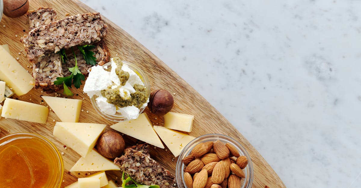 Is it ok to refrigerate almond milk after I add honey to it? - Brown Wooden Chopping Board With Brown Nuts and Sliced Cheese