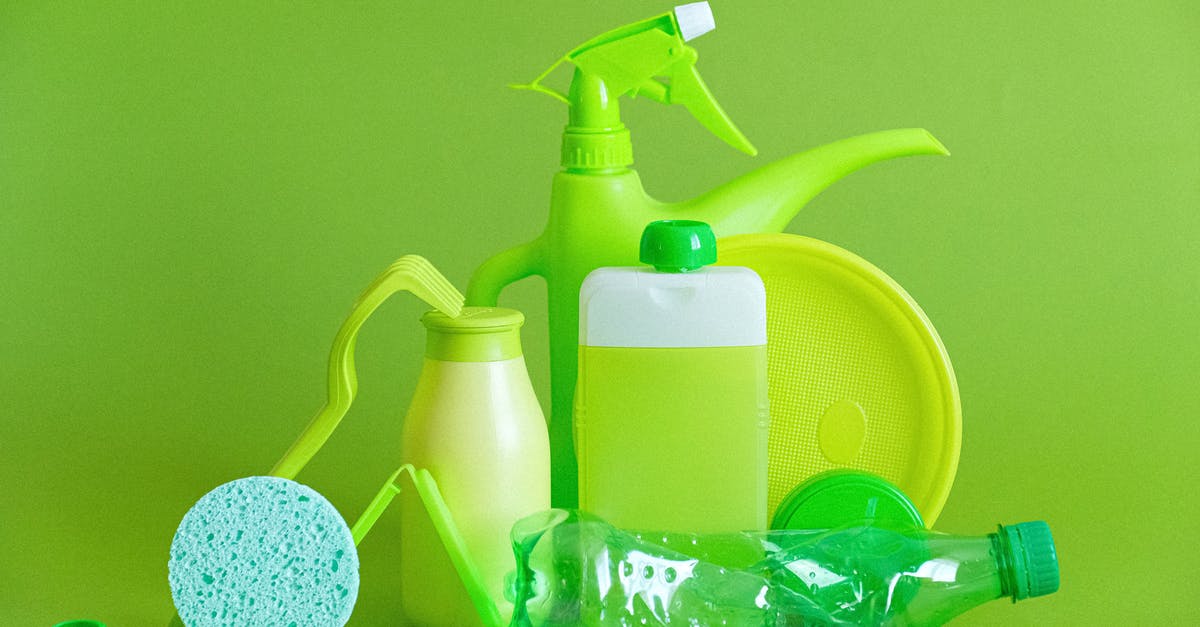 Is it okay to wash a plate at a later point? - Monochrome green bottles and containers for liquids or gel with plastic bottle and lids on green background