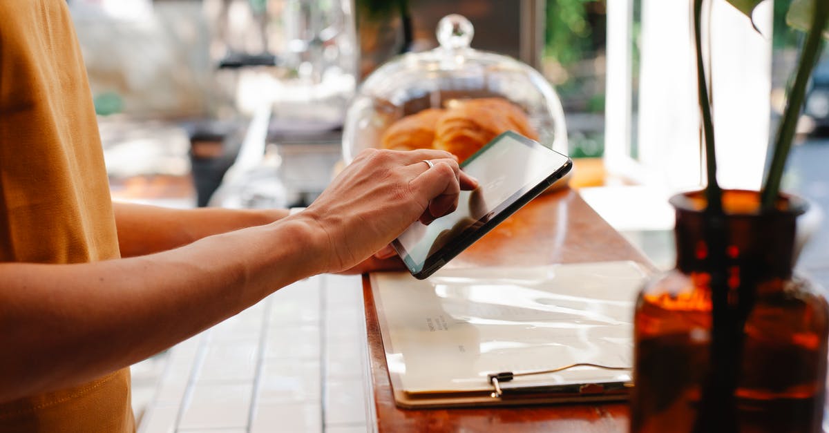 Is it possible to keep puff pastry dough in the fridge for future use? - Crop employee touching screen on tablet at cafeteria counter