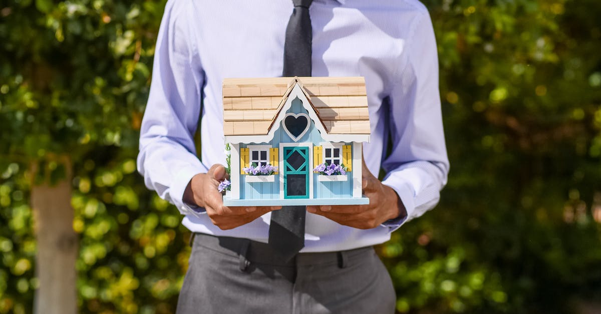 Is it possible to make a jam-setting gelling agent at home? - Person Holding a Miniature House