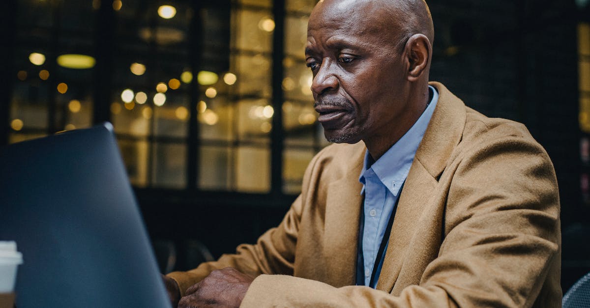 Is it possible to mature shop-bought hard cheese? - Focused mature African American businessman in suit surfing internet on netbook at table in cafeteria