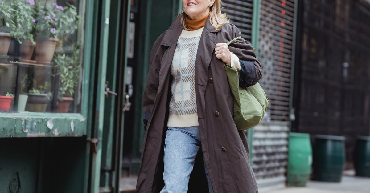 Is it possible to mature shop-bought hard cheese? - Middle aged female in coat and checkered sweater with bag walking on urban pavement while looking forward