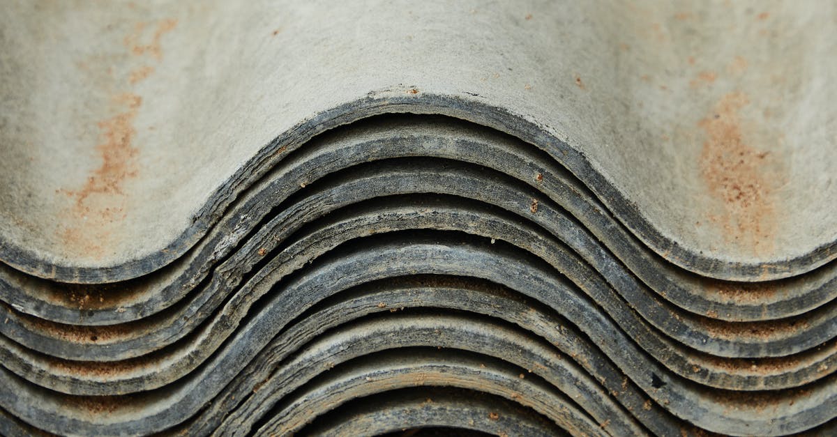 Is it possible to repair damage to the non-stick surface? - Background of heap of aged rough shabby slate for repairing roof of house