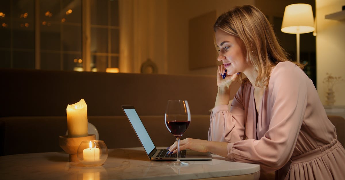 Is it safe to drink dark tea dating to 1970? - Woman in Pink Dress Shirt Sitting by the Table Using Macbook