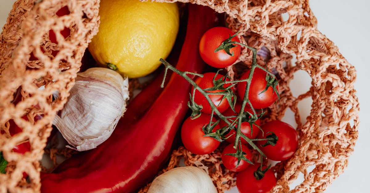 Is it safe to freeze raw garlic in vacuum-sealed (FoodSaver) bags? - Handbag with fresh assorted vegetables on table