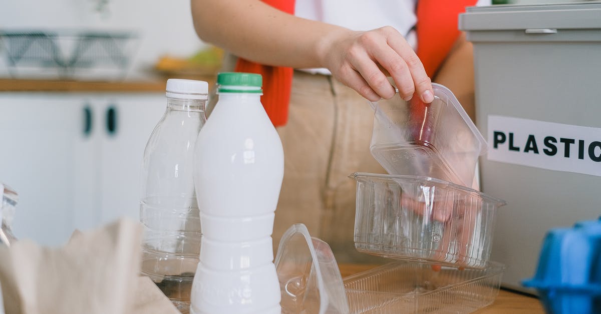 Is it safe to microwave Pyrex containers immediately after removing them from the freezer and removing the plastic lid? - Woman sorting out plastic wastes at home