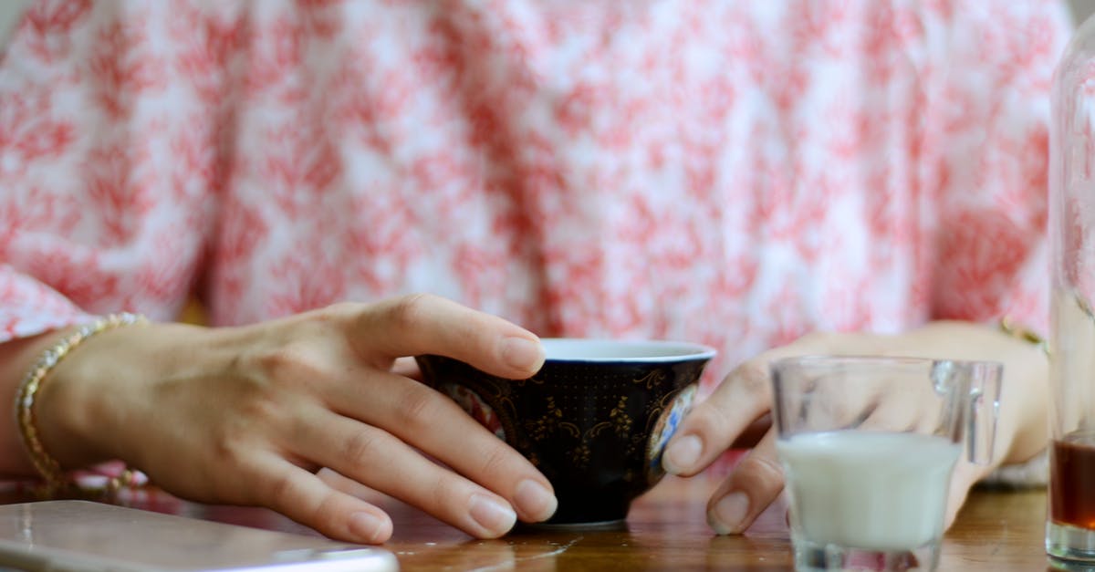 Is it safe to store hot tea in PET bottles? - Person Touching Ceramic Mug