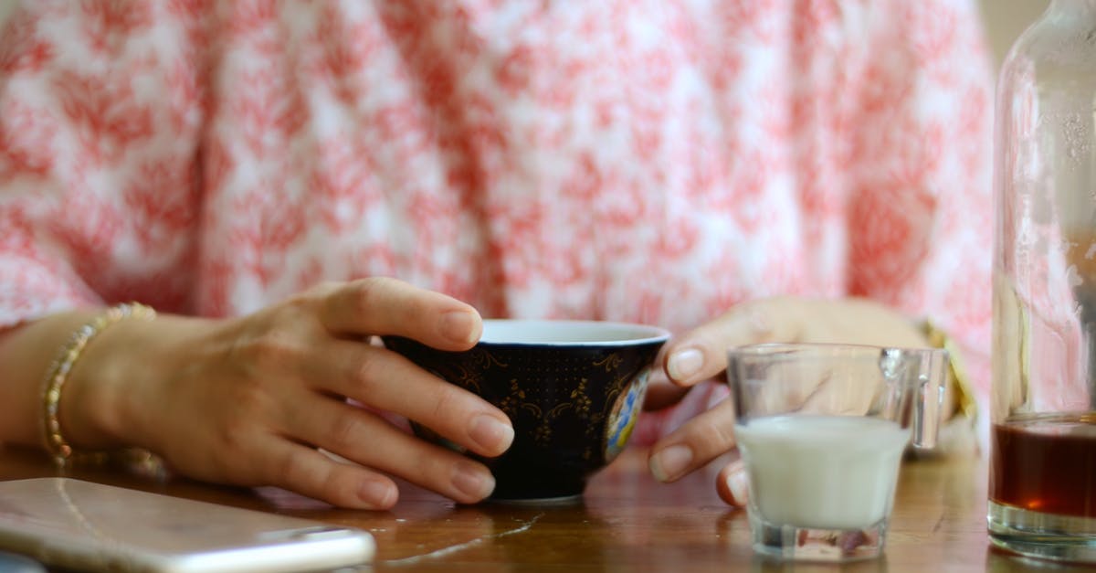 Is it safe to store hot tea in PET bottles? - Woman Holding Black Cup