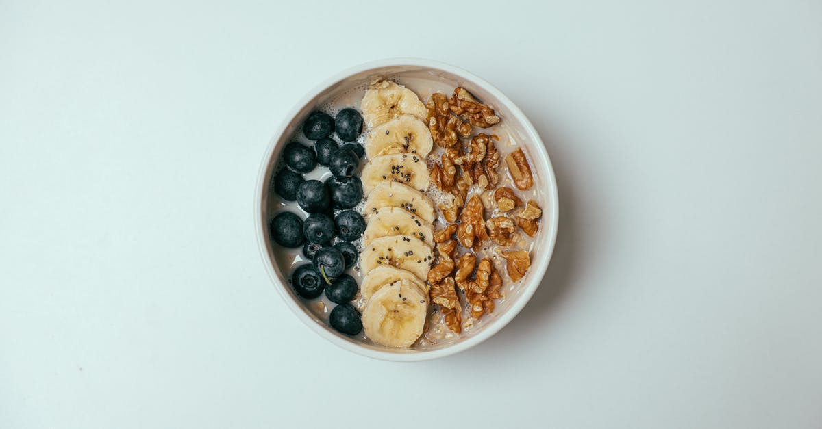 Is it scientifically verified that bananas will ripen faster when kept in a bowl with other fruit? - An Oatmeal with Fresh Fruits Topping on a White Surface