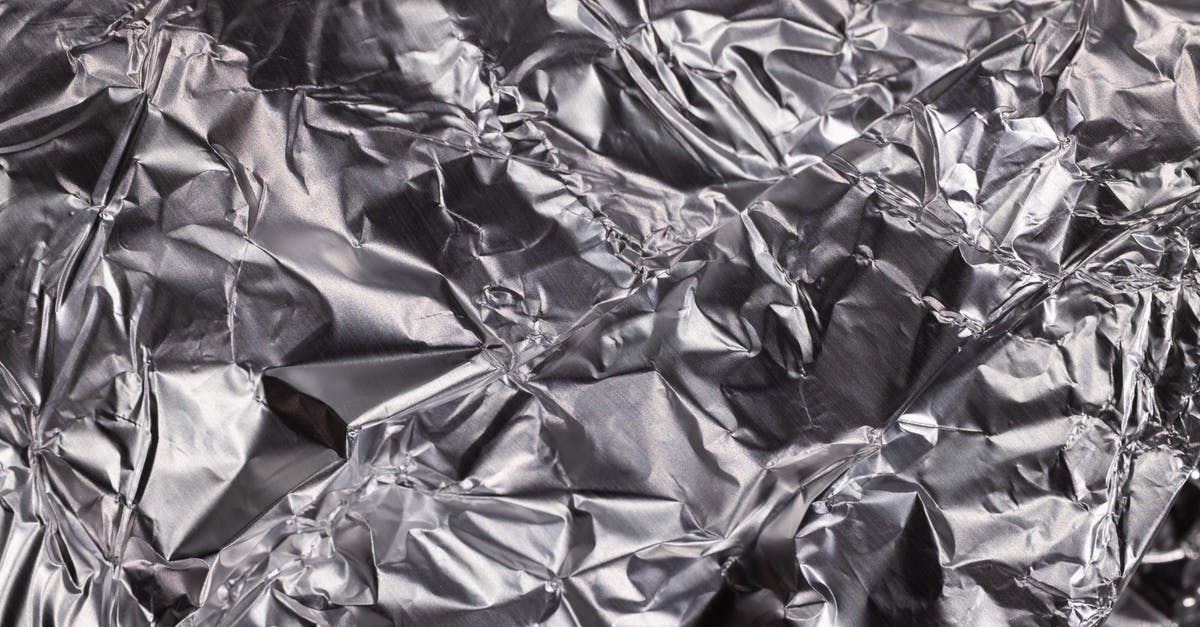 Is it wise to use an aluminum foil in the microwave? Is there a substitute for the aluminum foil? - Black and White Floral Textile