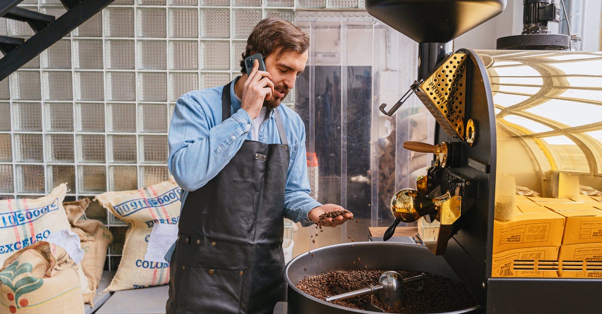 Is it worth checking beans for stones? - Man in Blue Dress Shirt Holding Black Smartphone