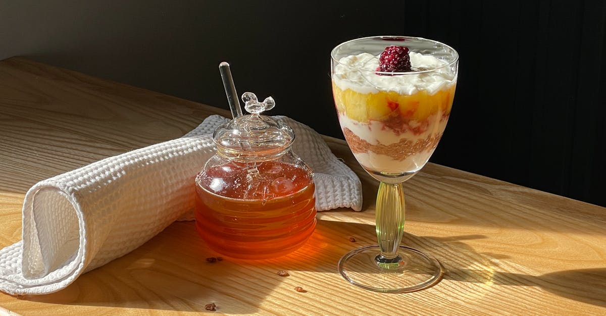 Is my honey fermenting? - Photo of a Drink Near a Jar of Honey