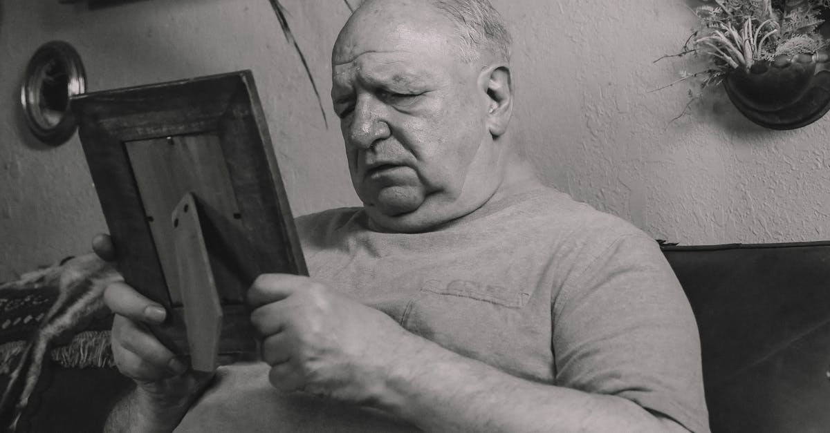 Is my ragu missing an ingredient? - A Grayscale Photo of an Elderly Man Holding a Wooden Frame