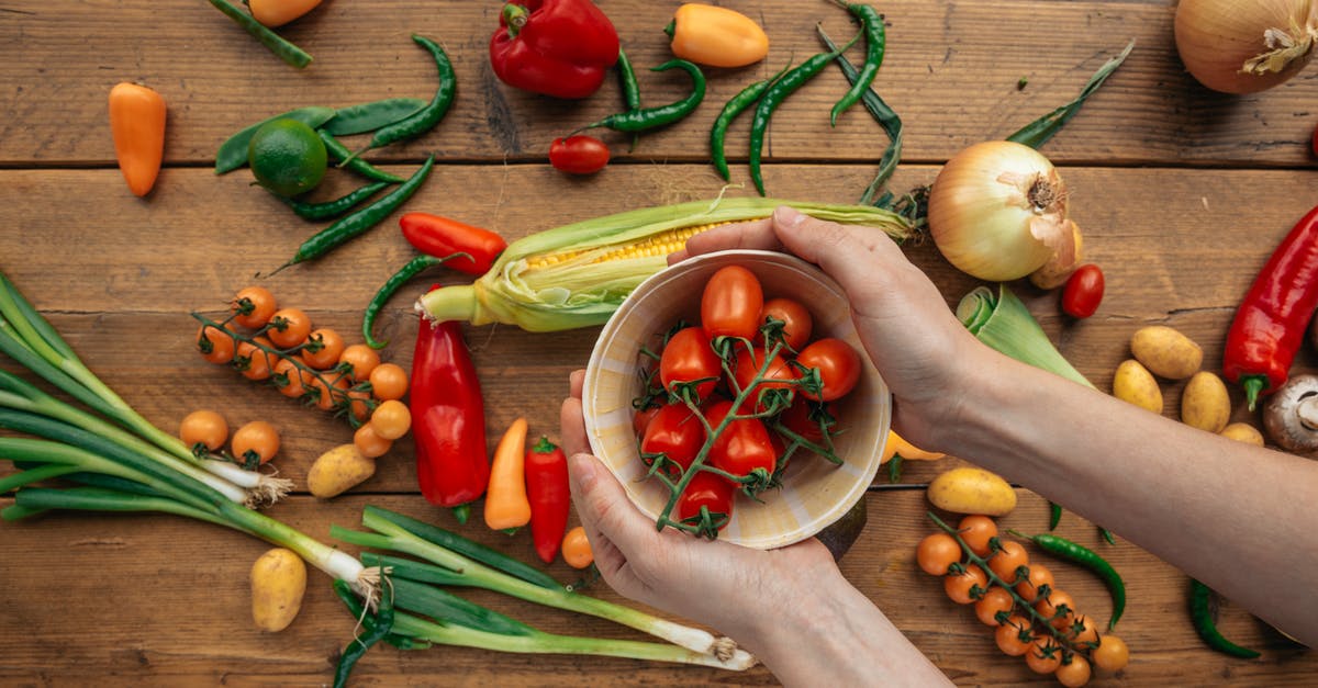 Is onion good with leek? - Person Holding a Bowl with Red Tomatoes