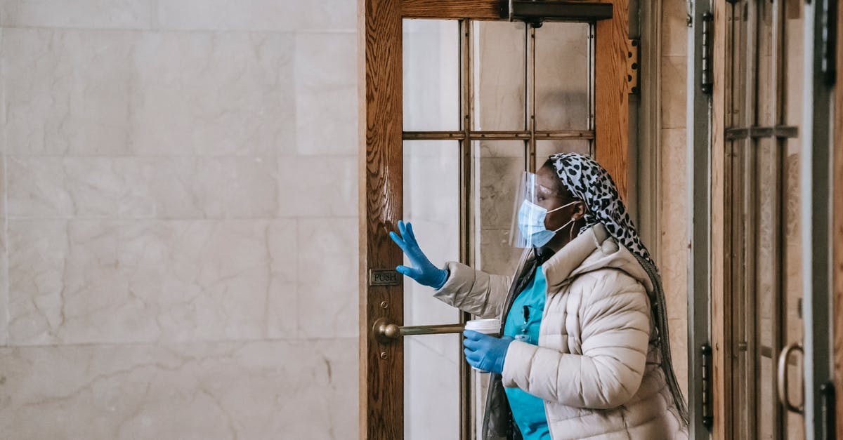 Is pre-cooked beef that's not completely dehydrated safe to leave out? - Black nurse in respirator and gloves leaving modern building