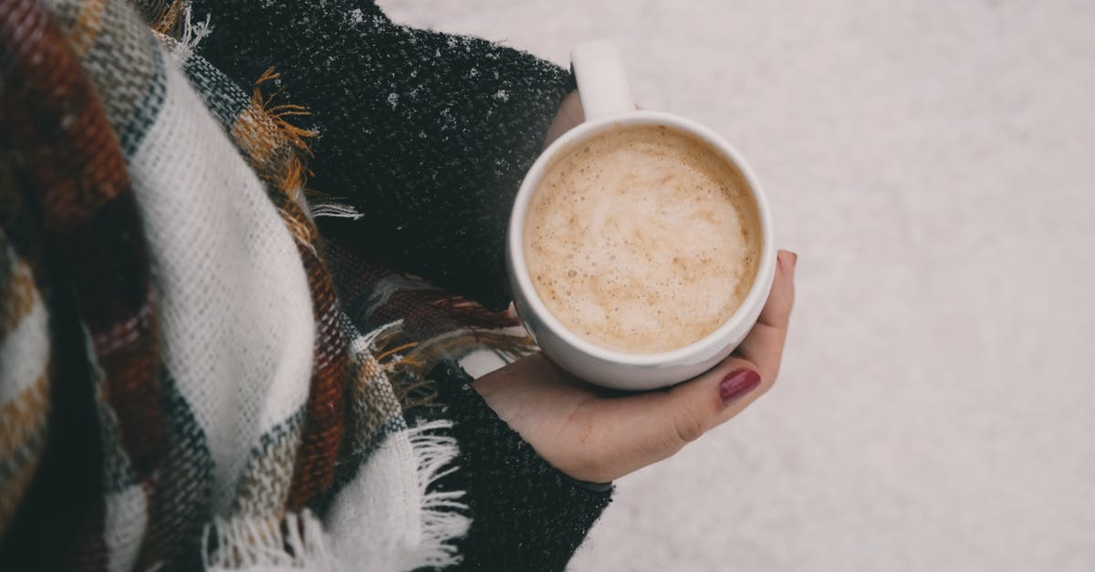 Is putting cold milk foam on hot coffee unsafe? - Person Holding Mug of Coffee