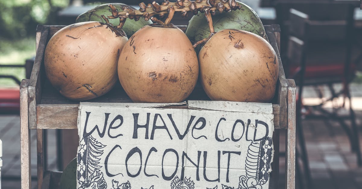 Is raw coconut safe to eat? - Tan Coconuts Placed Atop Brown Wooden Table