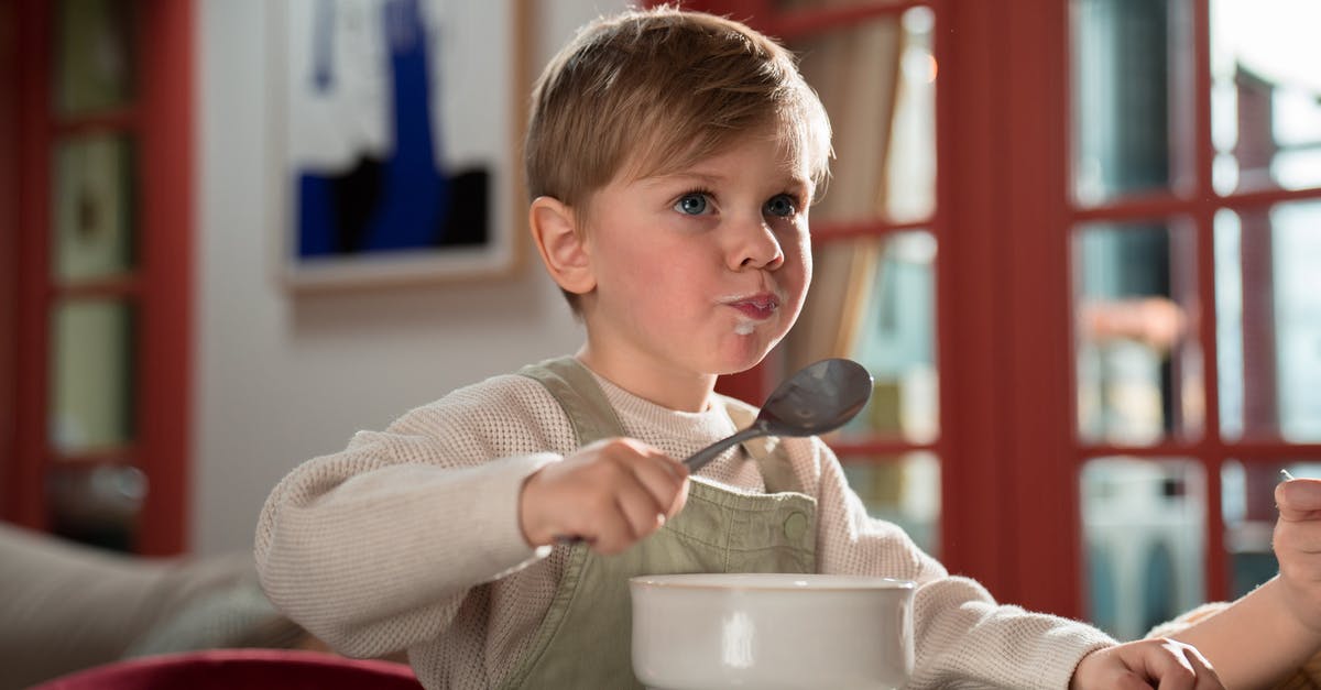 Is refreezing a meal safe? - Boy in White Sweater Holding Silver Spoon