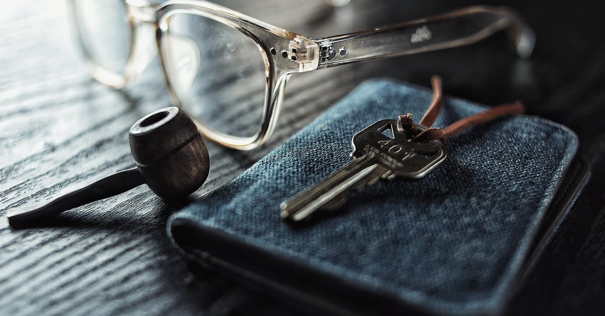 Is smoking with 'barked' wood dangerous? - Selective Focus Photo of Silver Key Beside Brown Smoking Pipe and Clear Eyeglasses