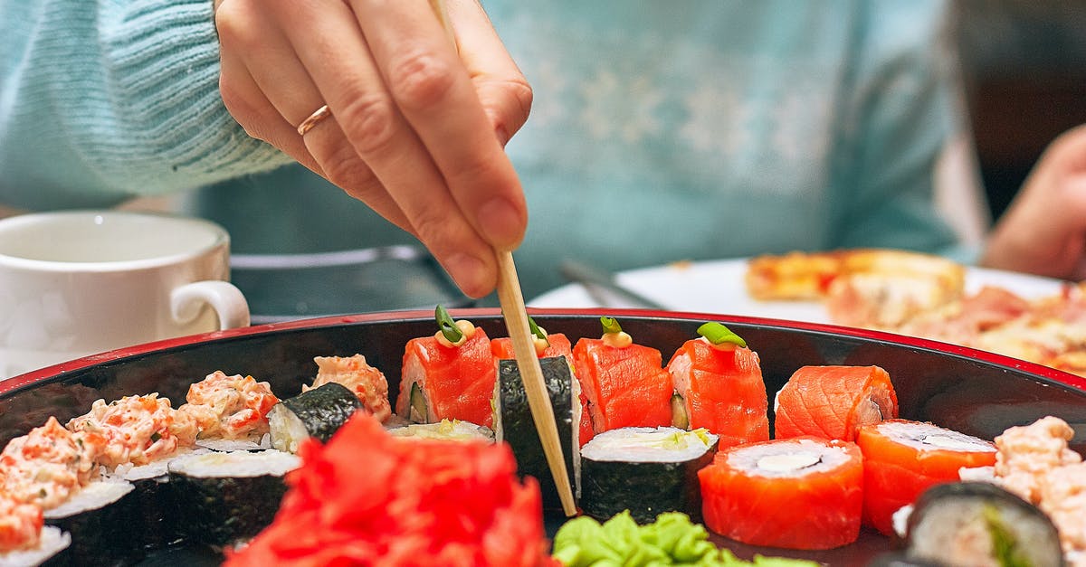 Is sushi so difficult? - Person Holding Brown Wooden Chopsticks