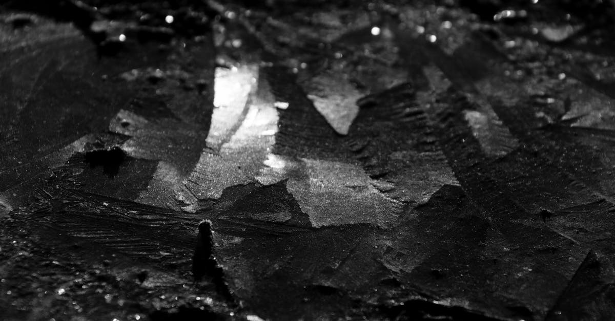 Is the milk spoiled when a thin layered textured appears in the bottom of pan? - Black and white closeup of abstract background representing dry inorganic material with rough uneven surface
