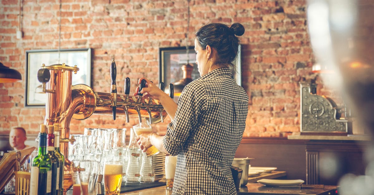 Is the pouring method of beer really important? - Photo of Bartender Pouring Draught Beer