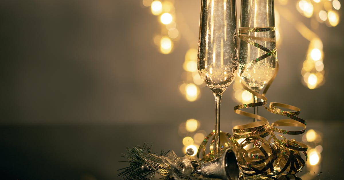 Is there a non-alcoholic beverage that has bubbles like champagne? - Close-Up Of Two Flute Glasses Filled With Sparkling Wine Wuth Ribbons And Christmas Decor