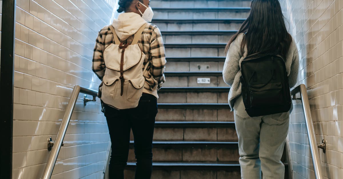 Is there a way to safely can pesto sauce? - Back view of African American female in mask walking on stairway in subway passage during coronavirus pandemic