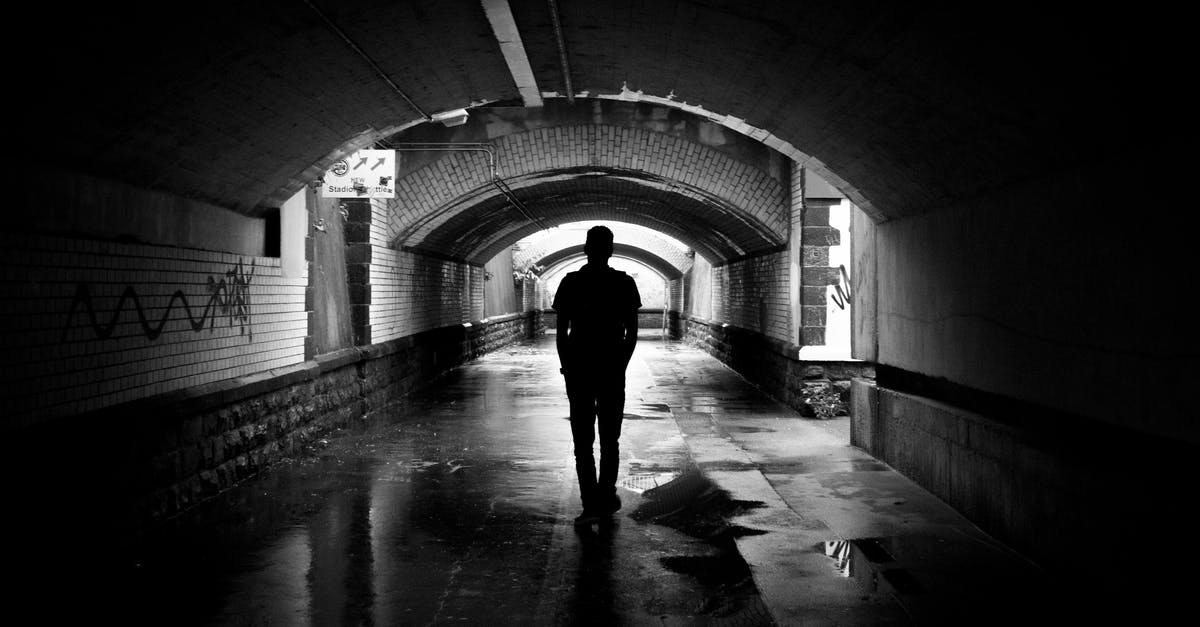 Is there a way to second-rise a wet dough in the same container? - Silhouette Photo of a Man in a Tunnel