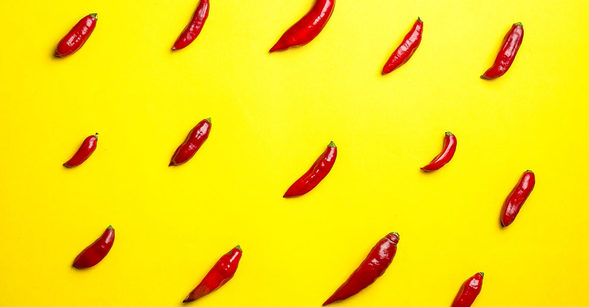 Is there any food ingredient that tastes like diesel smells? - Top view vibrant composition of spicy red chili peppers placed in rows on bright yellow background