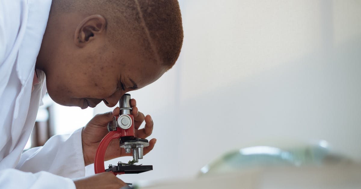 Is there any good way to check for honey adulteration besides a lab test? - Focused biologist studying plant leaf with microscope Is there any good way to check for honey adulteration besides a lab test? - Focused biologist studying plant leaf with microscope