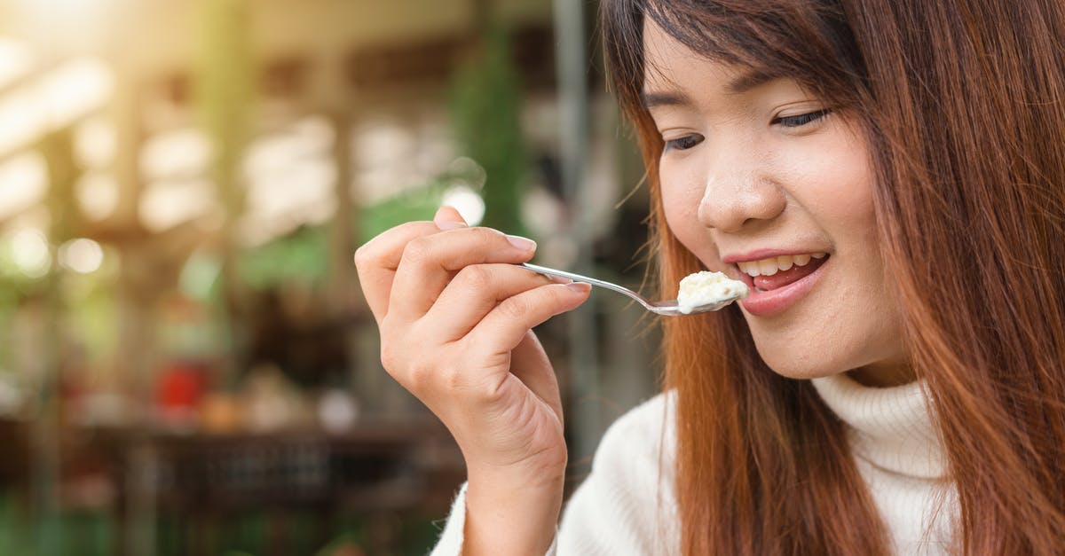 Is there any way to make single cream to double cream? - Woman Holding Spoon Trying to Eat White Food