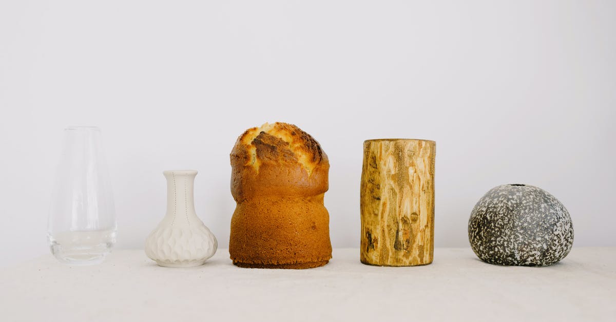 Is there really a tradition of some kind to eat white bread when it's hot outside and dark bread when it's cold? - Traditional Easter cake with wood chock and various vases placed on white table against white wall as symbol of traditional Easter holiday