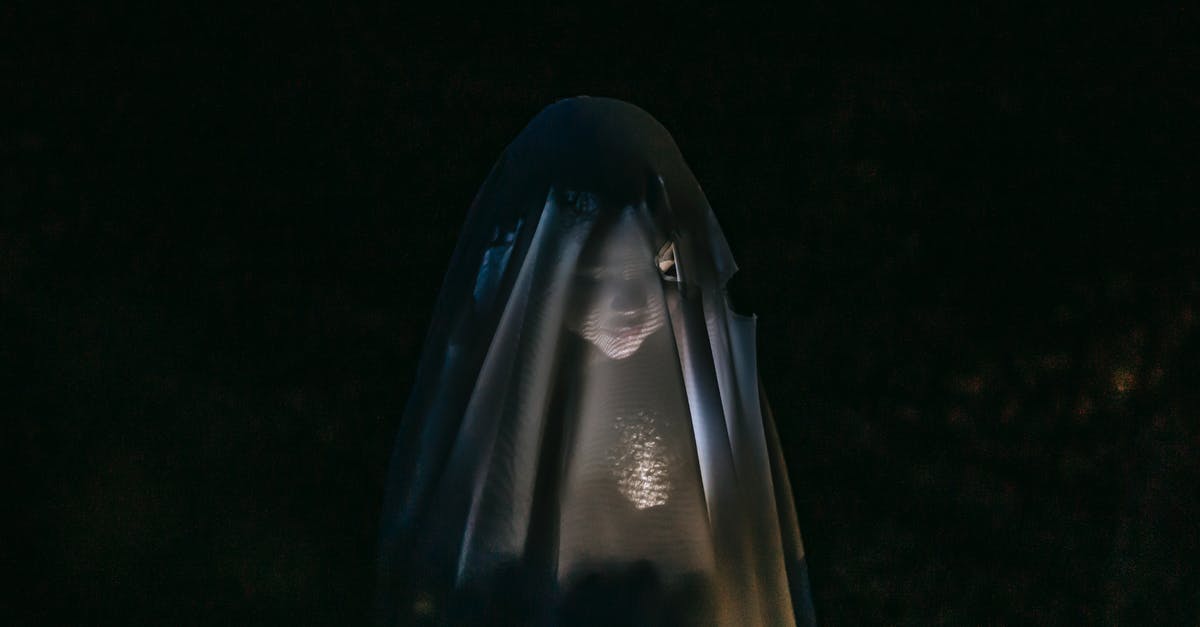 Is there some trick to vacuum sealing broccoli? - Mysterious little girl standing in darkness covered with white blanket as ghost and shining flashlight on face