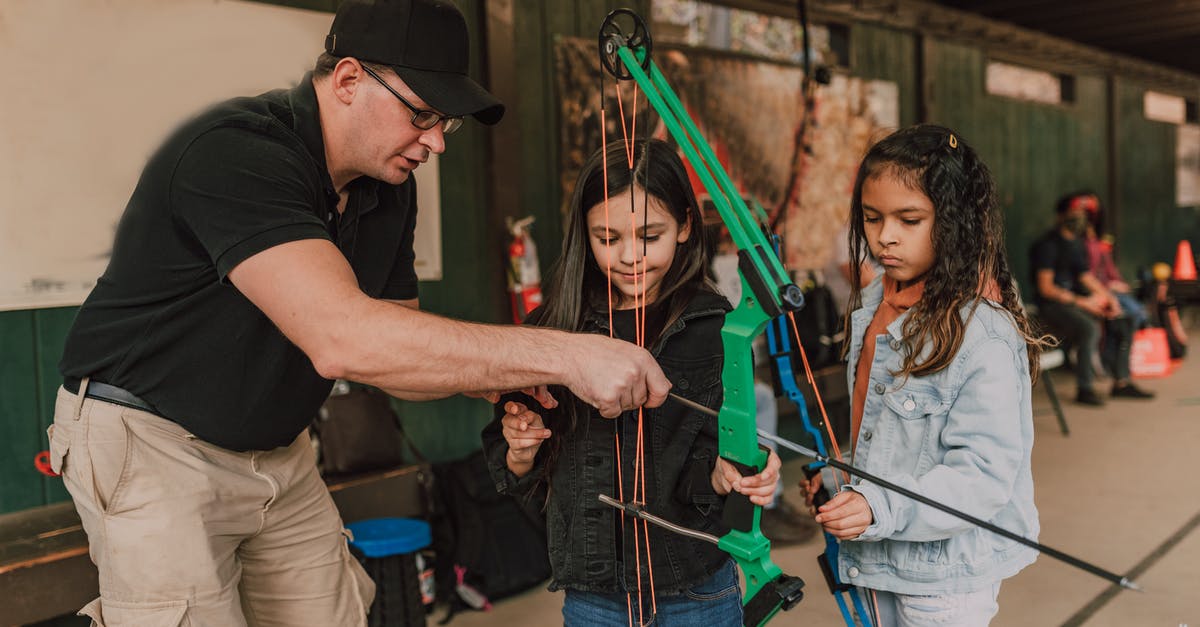 Is there somewhere I can see a diverse range of plating options? - Adult male archery coach teaching adorable little multiethnic girls to shoot with bow and arrow during classes in range