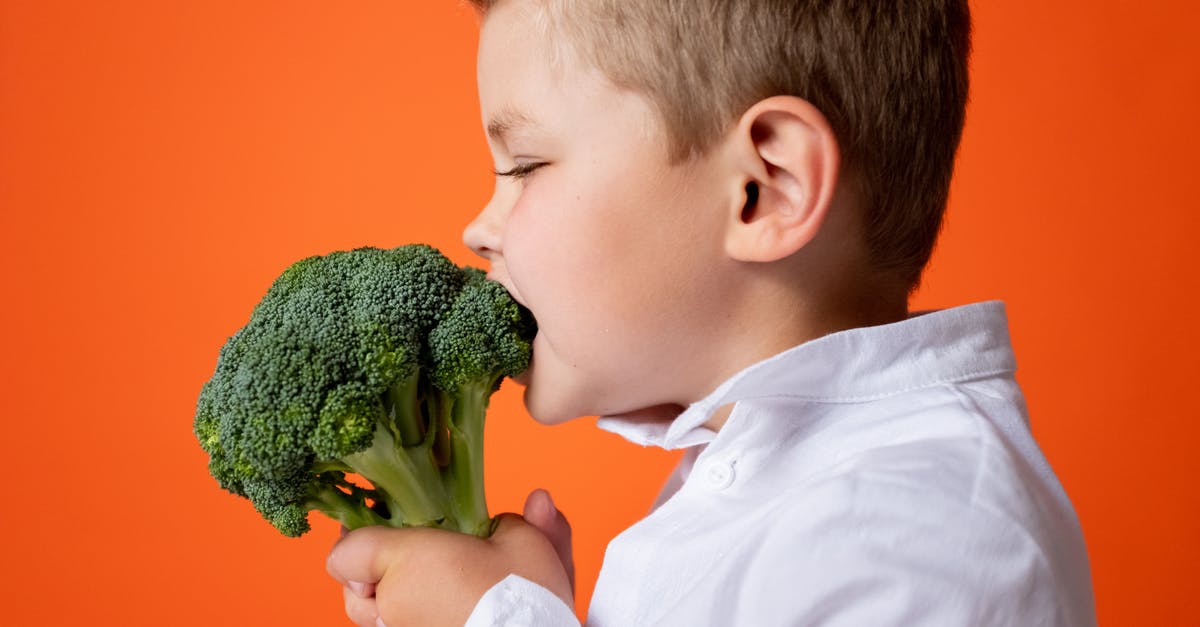Is this broccoli crown safe to eat? - Boy in White Dress Shirt Holding Green Vegetable