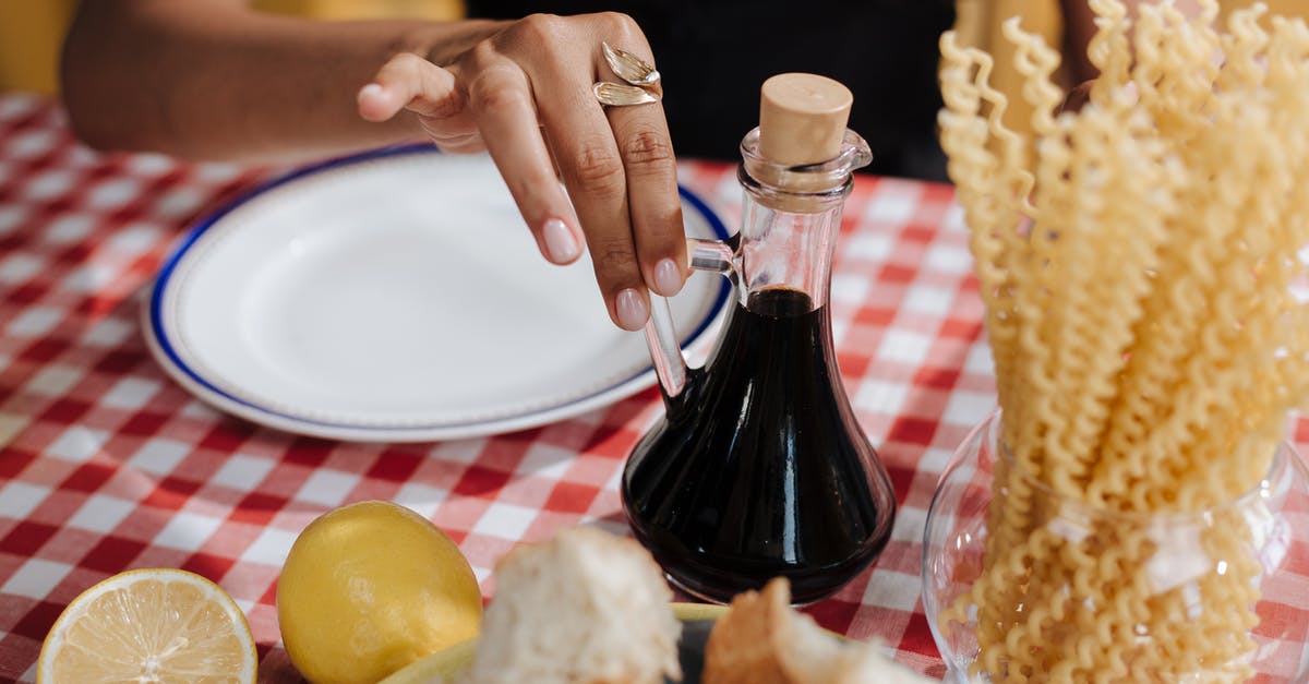 Is this moldy vinegar salvageable? [duplicate] - Close up on Woman Taking Vinegar Bottle