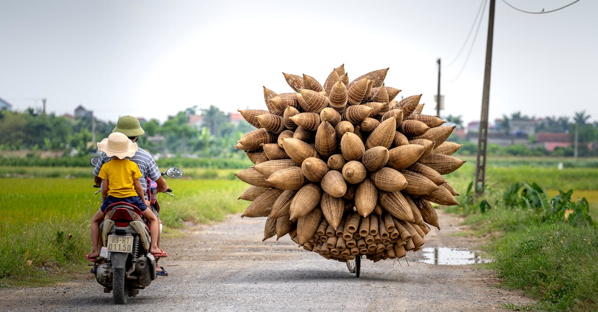 Is this the way to make good pies? - People driving motorcycle near bicycle with bamboo fish traps in countryside