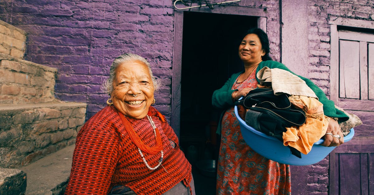 Is two-month old eggs laid by backyard chicken still edible? - Two Women Posing in Front of Slum Violet House