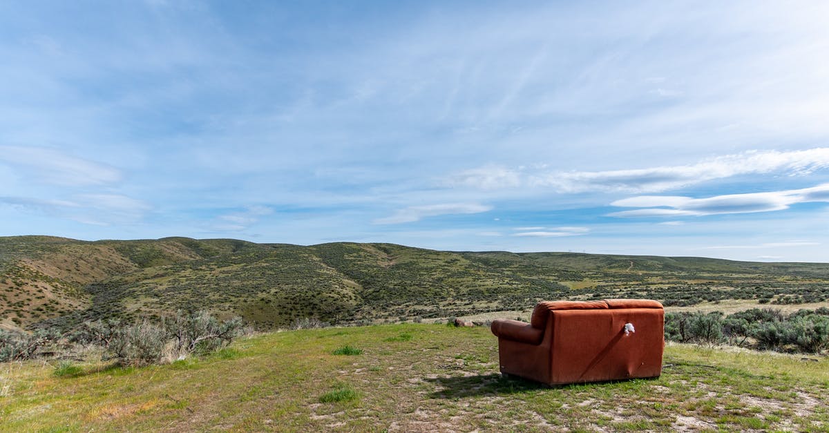 Is unnecessary refrigeration problematic? - Old sofa in green field behind mounts under bright sky