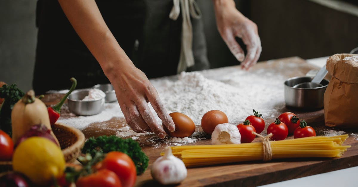 Is US flour significantly different than it used to be, or than flour outside of the US? - Cook preparing food dish standing at table with different ingredients