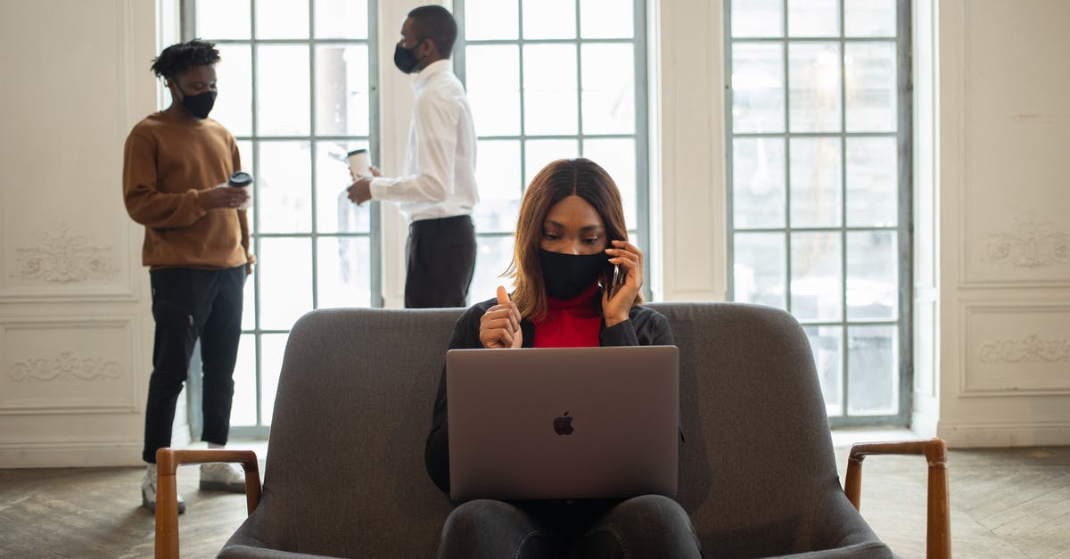 Is weak coffee more likely to be bitter? - Ethnic female worker in fabric mask with netbook and thumb up speaking on cellphone against male partners with takeaway coffee