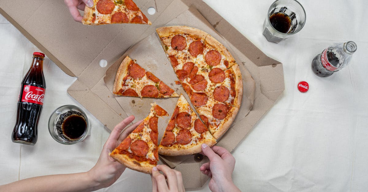 Israeli soda type drink - Person Holding Pizza on White Box